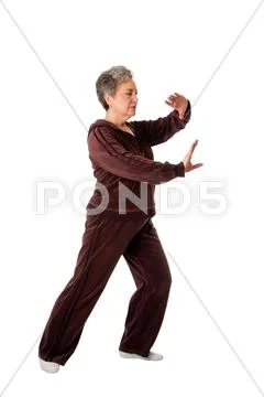 Senior woman doing tai chi yoga exercise Stock Photos