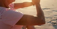 Senior Woman Doing Yoga On The Beach Stock Footage