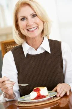 Senior Woman Eating Cheesecake Stock Photos