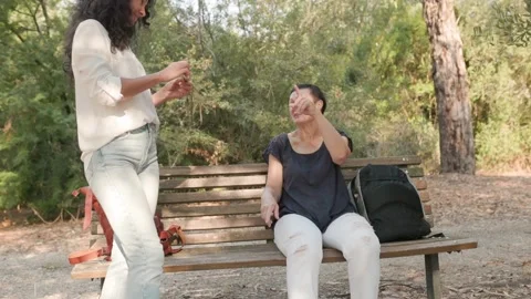 Senior woman gesturing while talking with younger woman outdoors Stock Footage 317742276