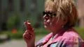 Senior woman with glasses smoking a cigarette, female smoker HD Footage