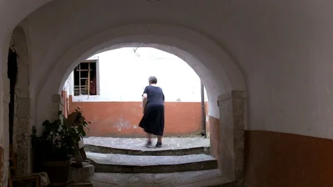 Senior woman going home alone Stock Footage