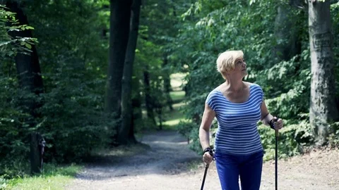 Senior woman hiking in forest Stock Footage