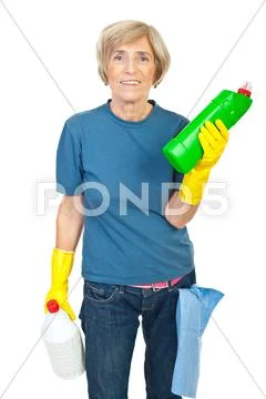 Senior woman holding cleaning products Stock Photos