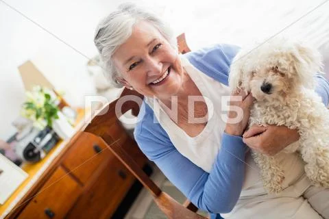 Senior Woman Holding A Dog