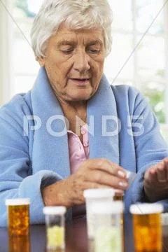 Senior Woman Holding Pills
