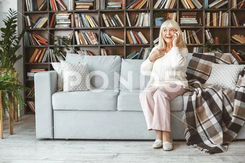Senior woman at home retirement concept sitting phone call cheerful Stock Photos