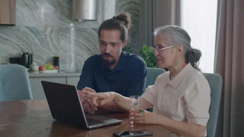 Senior Woman Learning How to Use Laptop from Social Worker at Home Stock Footage 337008236