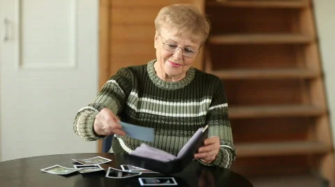 Senior woman looking photo Stock Footage