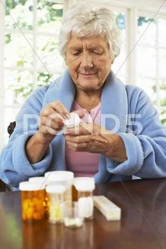 Senior Woman Looking At Pill Bottle Label