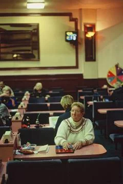 Senior Woman Playing Bingo in Old Traditional Bingo Hall Stock Photos