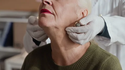 Senior Woman Receiving Lymph Node Examination from Doctor Stock Footage 339614066