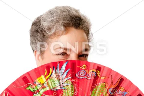 Senior woman with red dragon fan Stock Photos
