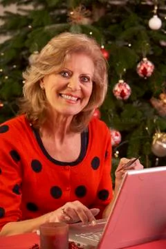Senior Woman Shopping Online For Christmas Gifts Stock Photos