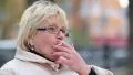 Senior woman sits on the bench near the road and smokes a cigarette HD Footage
