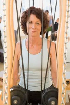 Senior woman sitting in exercise equipment Stock Photos