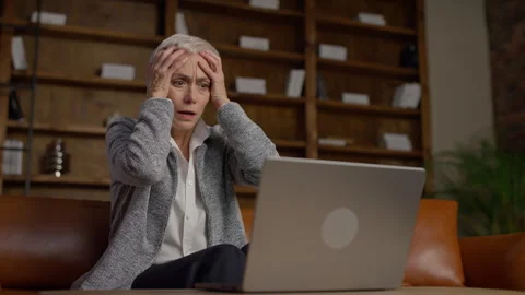 Senior woman stressed while using laptop Stock Footage 297946340