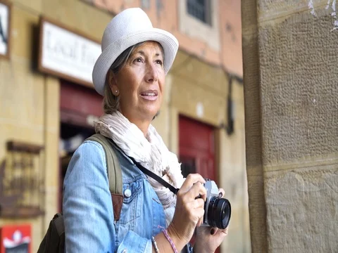 Senior woman taking pictures on tourist journey Stock Footage