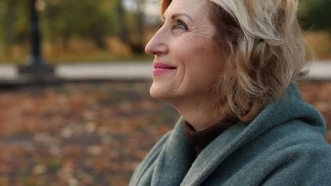 Senior woman thanks God for fulfilled desire, miracle. Beautiful face in profile Stock Footage