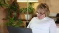 Senior woman types text uses laptop. Woman with notebook HD Footage