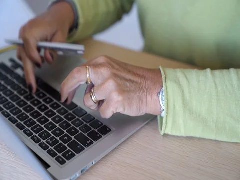 Senior woman typing on laptop keyboard Stock Footage