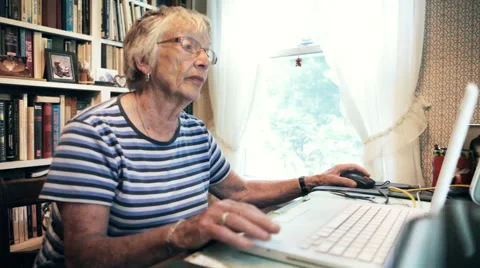 Senior Woman Using Computer Internet Technology to do Online Shopping at Home Stock Footage 51025955
