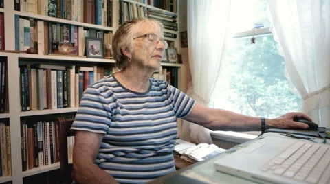 Senior Woman Using Computer Technology to Browse the Internet at Home Stock Footage 50980578