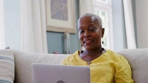 Senior Woman Using Laptop To Connect With Family For Video Call Stock Footage