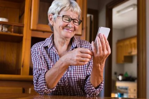 Senior woman using phone, making video call Stock Photos