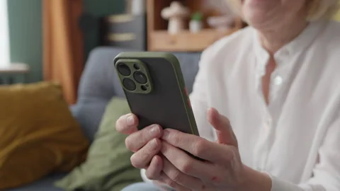 Senior Woman Using Smartphone While Relaxing In Cozy Living Room At Home Stock-Footage 334737838