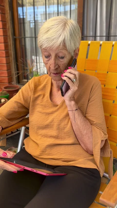 Senior woman using tablet and smartphone Stock Footage 301804928