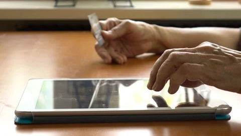 Senior Woman Using Tablet Computer and credit card, shopping online 스톡 동영상 130105101