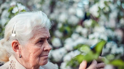 Senior woman using tablet to take photos Stock Footage 62862632