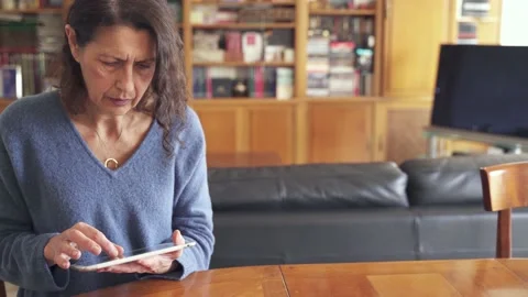 Senior woman using tablet with touchscreen Stock Footage 188938869