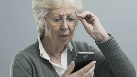 Senior woman with vision problems using a smartphone Stock Footage 104409521
