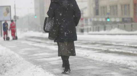 A senior woman walking over pile of snow Stock Footage 59641842