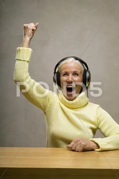 Senior woman wearing headphones, laughing, close-up Stock Photos