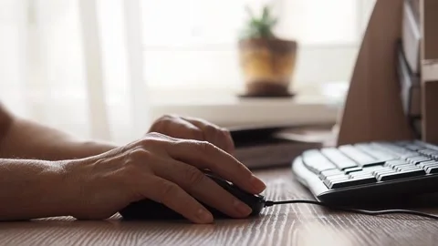 Senior woman's hand uses computer mouse Stock Footage 237516650
