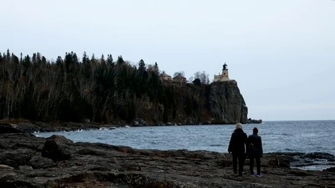 Senior women exploring shoreline at Split Rock Lighthouse on the north shore. Stock Footage 99162959