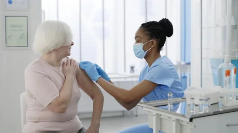 Senior women processing vaccination procedure in private clinic hospital Stock-Footage 150559141