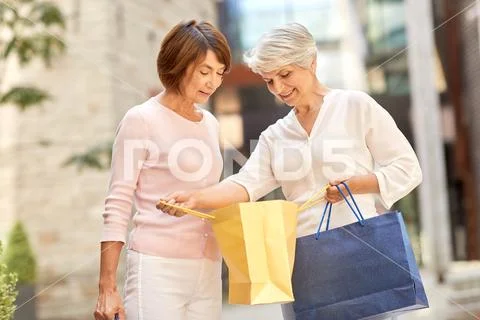 Senior women with shopping bags in city Stock Photos