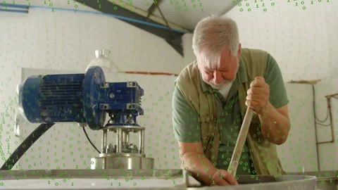 Senior worker inserting rod and stirring tank in plant, checking contents, green Vídeos de archivo 331736166