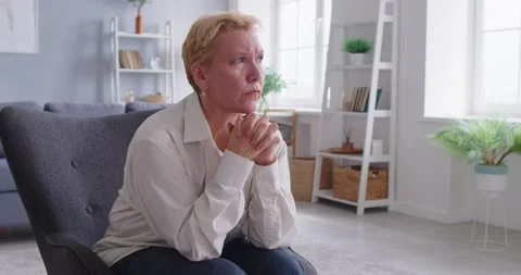 Senior worry, unhappy alone old woman sitting at home feeling depressed, sad Vídeo Stock 313344316