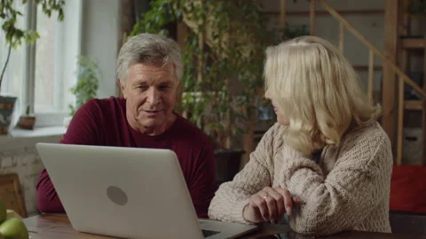Seniors are choosing something on the Internet and discussing Stock Footage 170272107