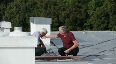 Seniors checking and maintaining rooftop Stock Footage