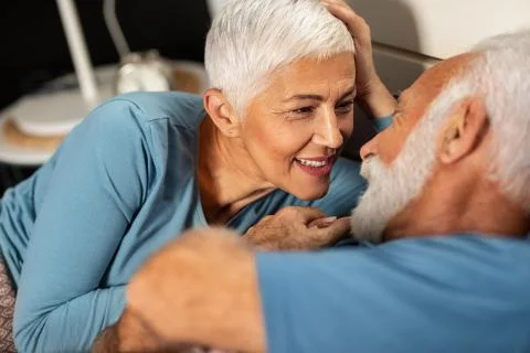Seniors cuddle in bed Stock Photos