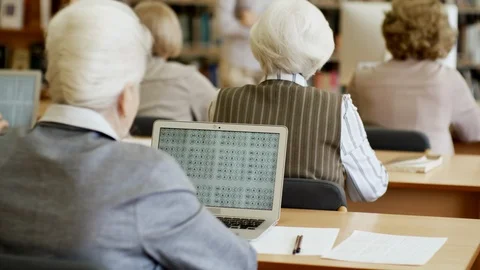 Seniors Doing Coding Task on Computers Stock Footage 99257869