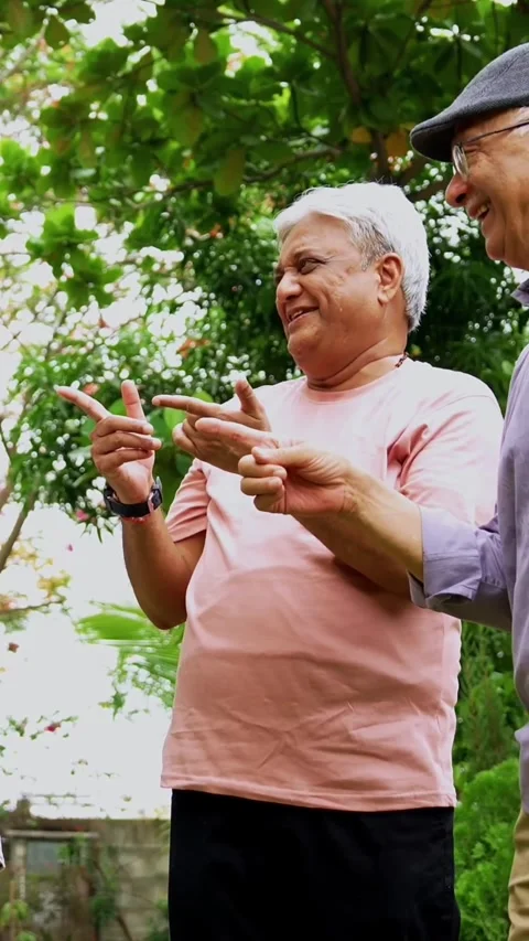 Seniors doing group huddle cheer together outdoors in garden Stock-Footage 342387138