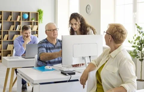 Seniors Learning Computers with Instructor in Classroom Training, Adult Stock Photos