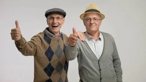 Seniors making a thumb up gesture and smiling Stock Footage
